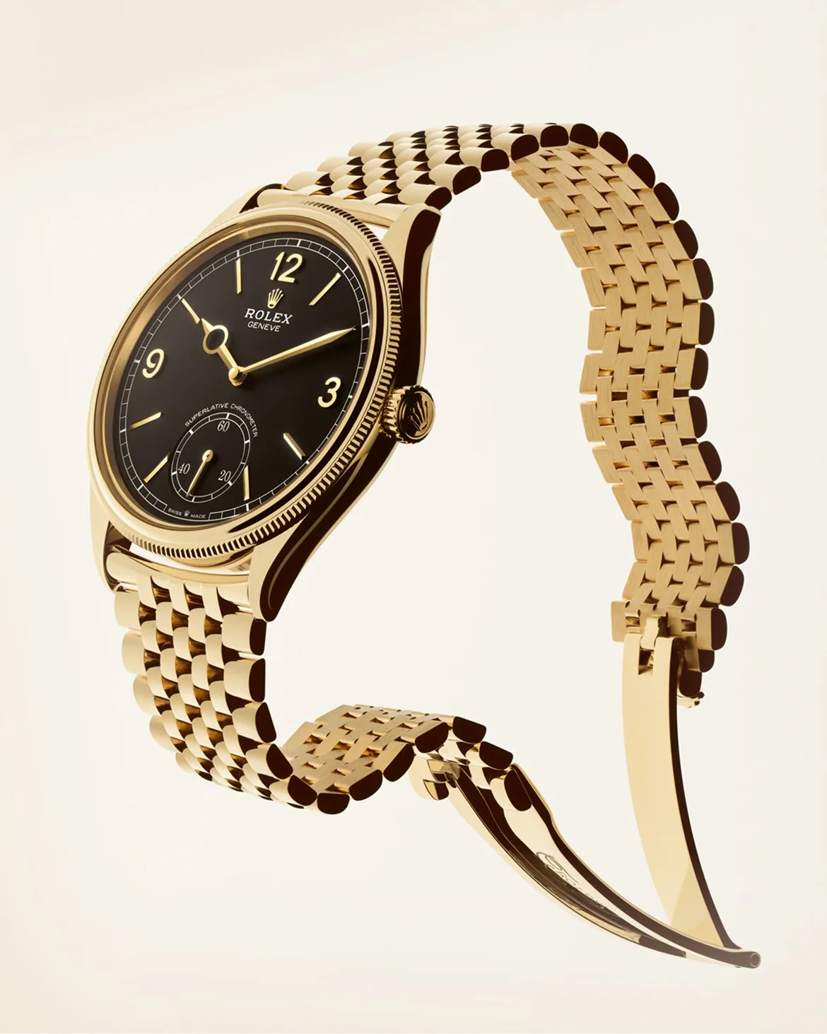rolex-perpetual-1908-m52509-0006_2302uf_002_portrait Gold Rolex wristwatch with a black dial and gold link bracelet, angled to show the face and crown.
