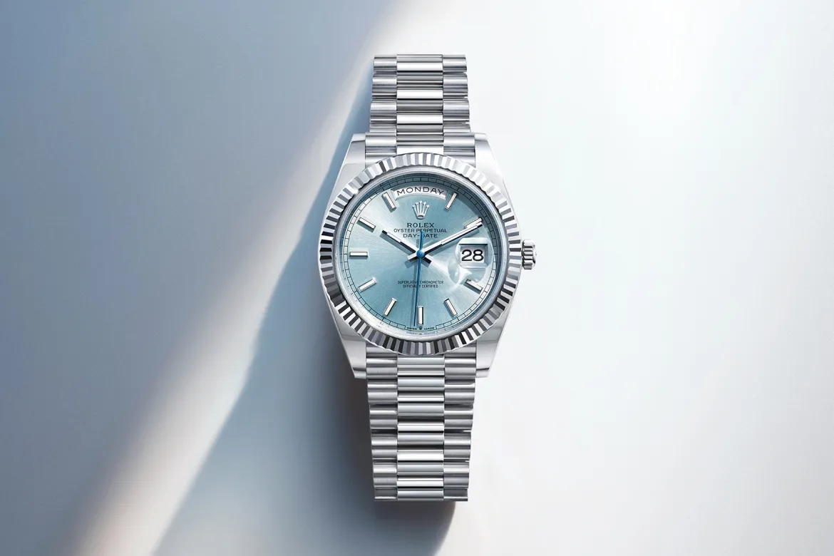 rolex-watches-day-date-m128236-0018-landscape | Brela Rolex Day-Date wristwatch with a blue dial, fluted bezel, and stainless steel bracelet showing day and date. | Brela
