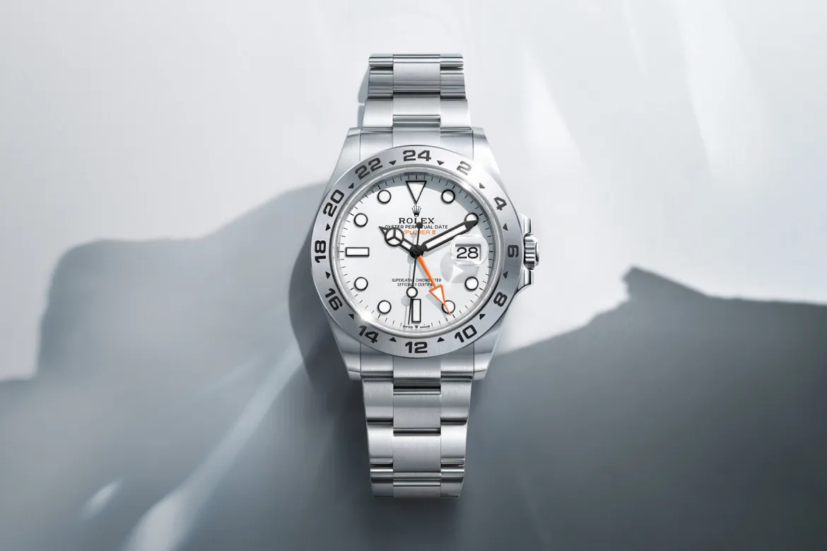 rolex-watches-explorer-ii-m226570-0001-landscape | Brela Stainless steel Rolex watch with white dial, date window at 3 o'clock, and orange 24-hour hand. | Brela