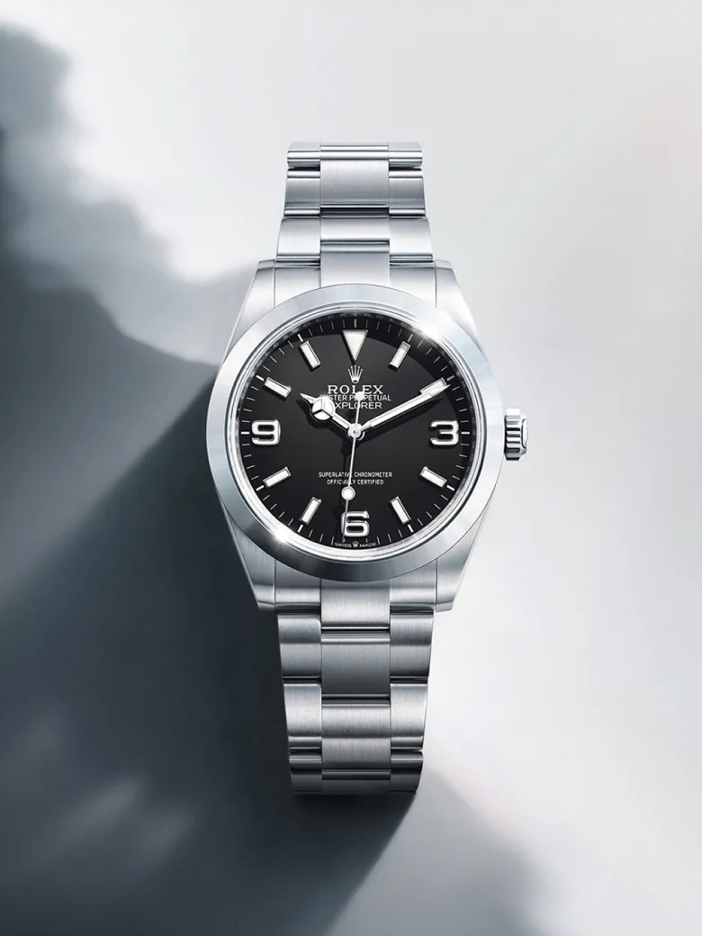rolex-watches-explorer-m224270-0001-portrait | Brela Stainless steel Rolex Explorer watch with a black dial and silver bracelet on a light background. | Brela