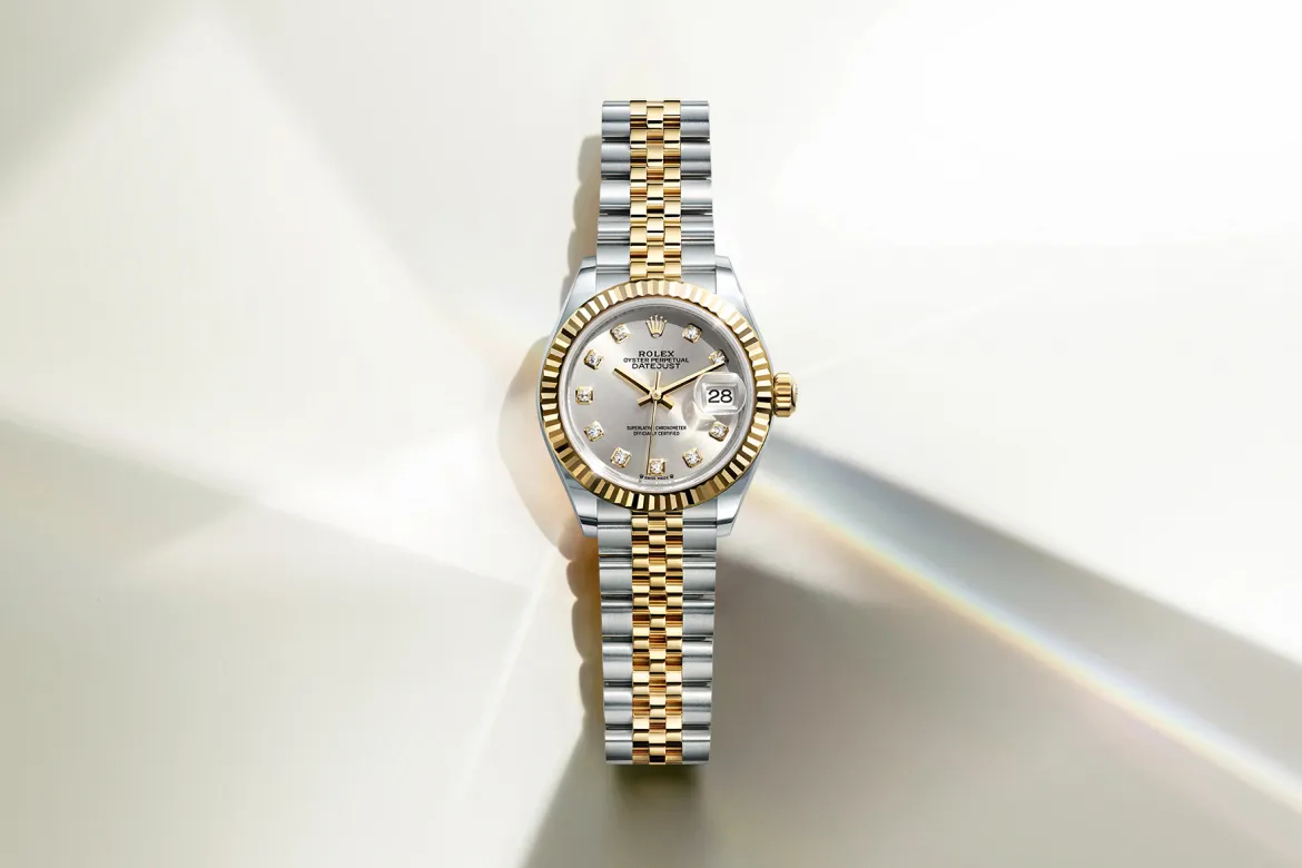 rolex-watches-lady-datejust-m279173-0007-landscape | Brela Two-tone Rolex Datejust with gold and steel bracelet, diamond hour markers, and date window on a pale background. | Brela