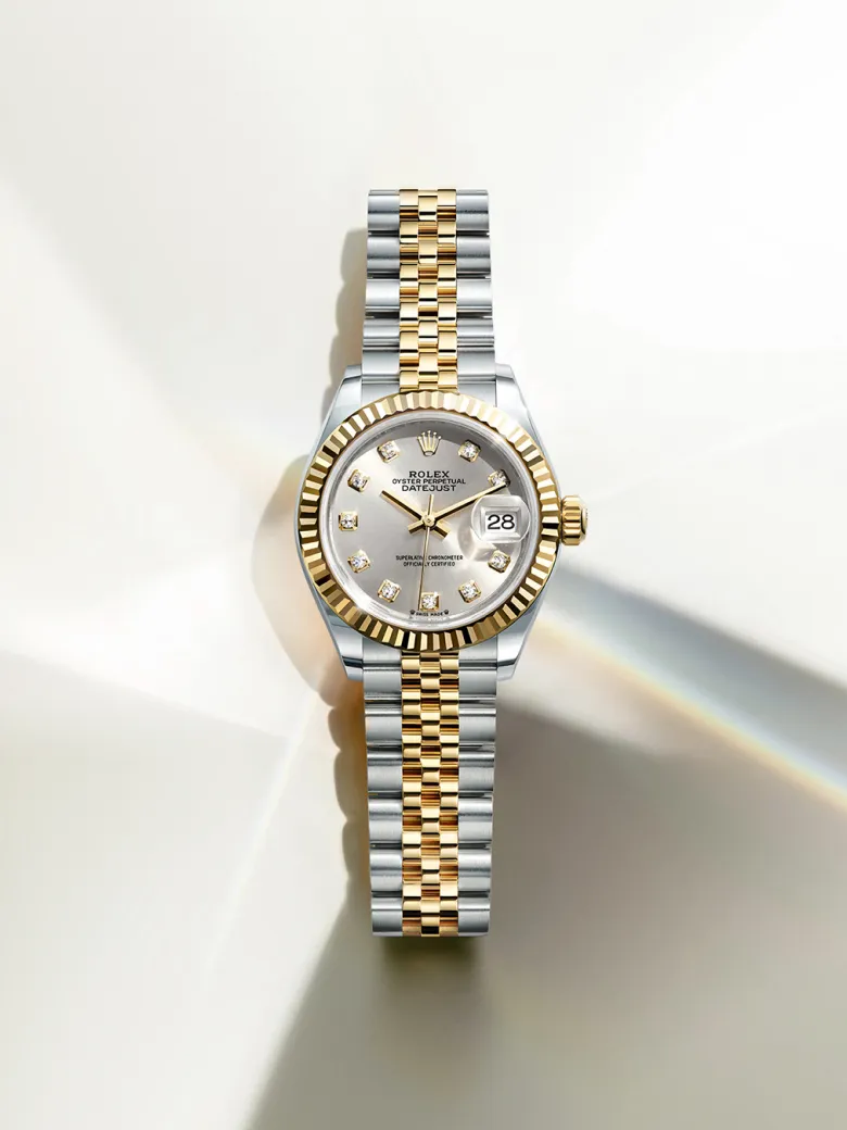 rolex-watches-lady-datejust-m279173-0007-portrait | Brela Two-tone Rolex Datejust watch with gold bezel, silver dial, diamond hour markers, and date window | Brela