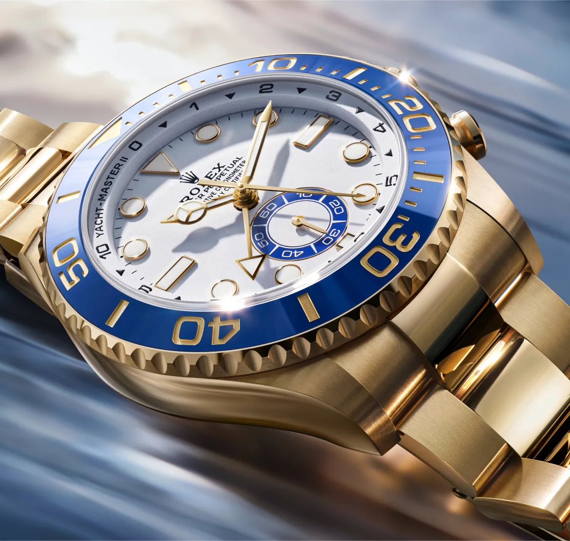 Close-up of a gold Rolex Yacht-Master watch with a white dial and blue bezel.