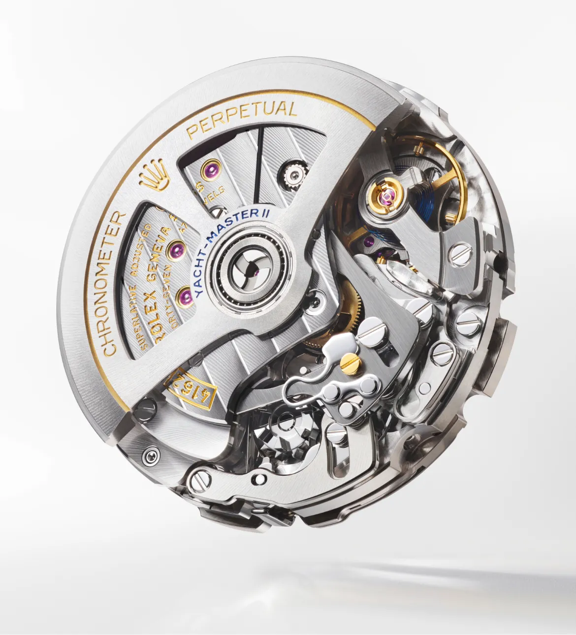 Close-up of a Rolex Yacht-Master II watch movement showing gears, screws, and gold rotor; a detailed view of the mechanical inner workings.
