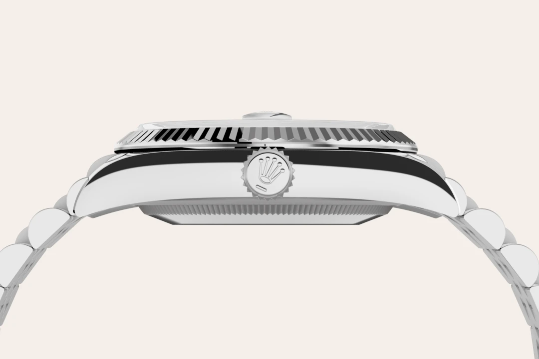 Close-up side view of a polished Rolex watch case and crown, featuring the Rolex logo on the crown | Brela