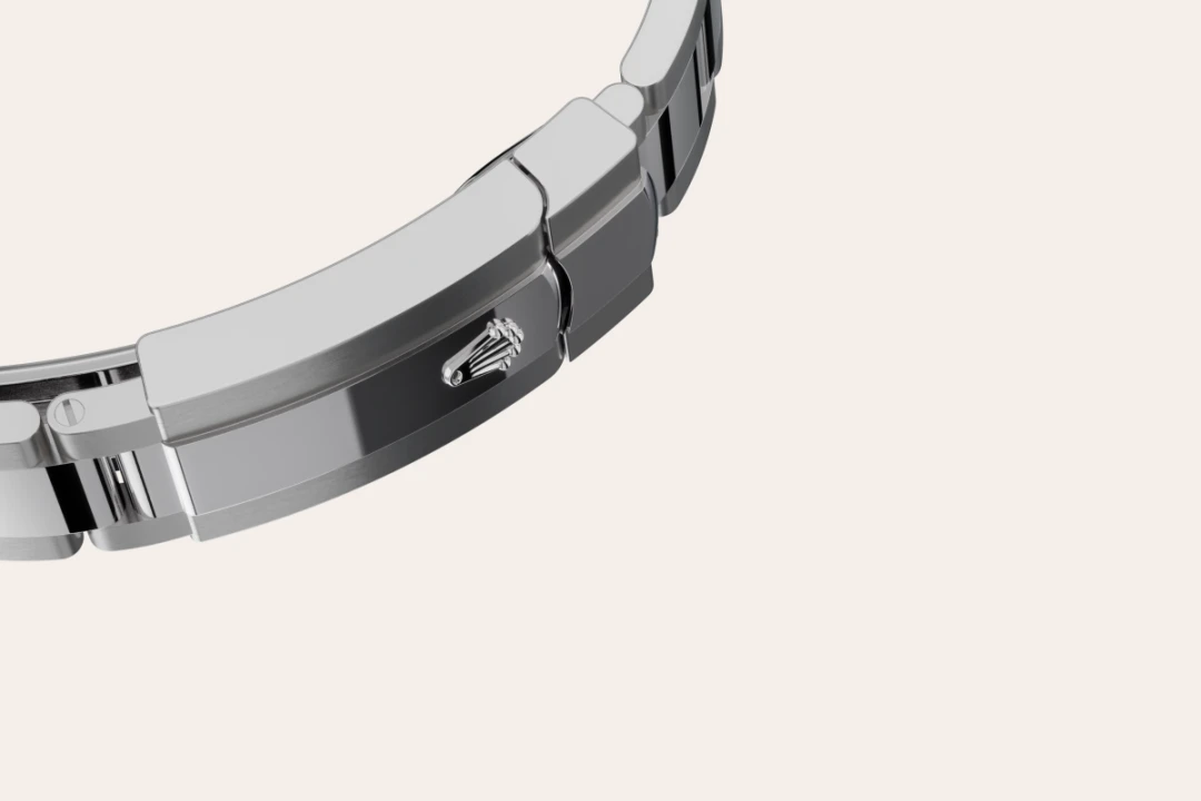Close-up of a stainless steel watch bracelet folding clasp, featuring a Rolex crown logo on the clasp. | Brela