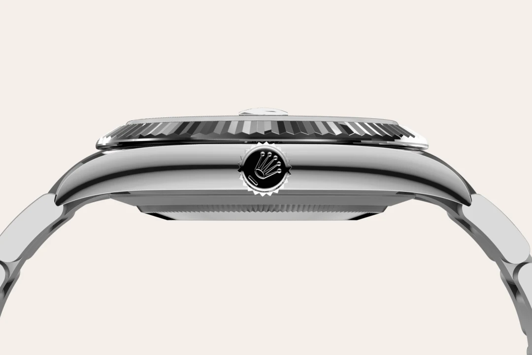 m126334-0033-material-landscape | Brela Close-up side view of a polished stainless steel wristwatch, showing a fluted bezel and the crown with a Rolex logo. | Brela