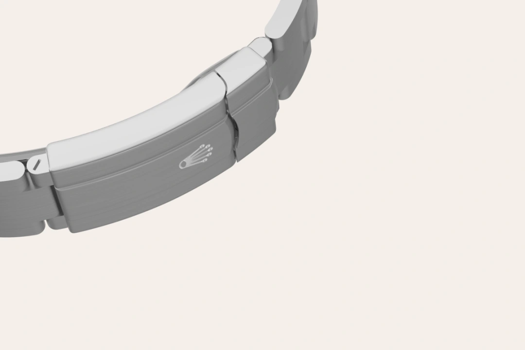 m134300-0004-bracelet-landscape | Brela Close-up of a metal watch bracelet with a small Rolex crown logo on the clasp. | Brela