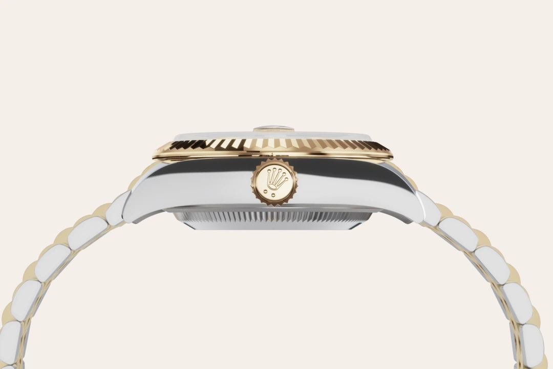 Side view of a two-tone Rolex watch with a gold crown and fluted bezel | Brela