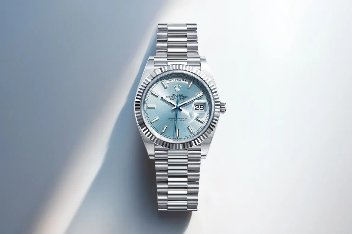 rolex-day-date-cover-m128236-0018-portrait Rolex Day-Date stainless steel watch with pale blue dial, fluted bezel, and date window showing 28.