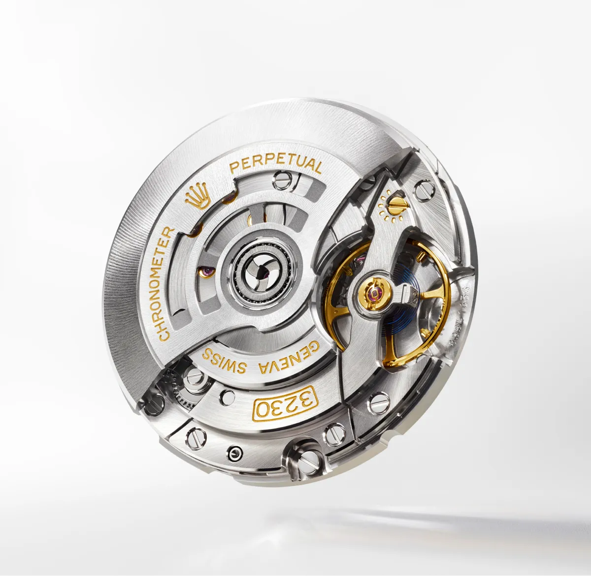 rolex-explorer-movement-3230-landscape Close-up of a Rolex perpetual Swiss watch movement rotor in silver with gold accents and visible gears and screws.
