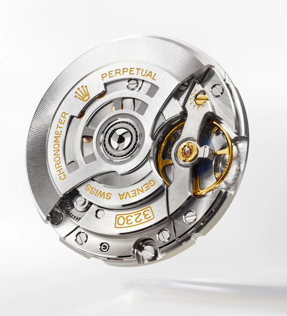 rolex-explorer-movement-3230-portrait Close-up of a Swiss watch movement with a rotating rotor, visible gears, and gold accents; engraved words include CHRONOMETER, PERPETUAL, and GENEVA SWISS.