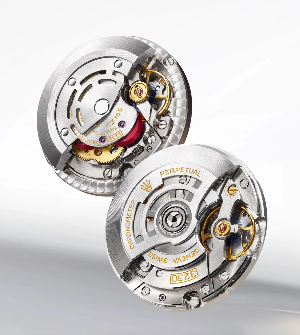 rolex-oyster-perpetual-movement-2232-portrait Close-up of two silver Rolex watch movements with gold gears and visible inner mechanism.
