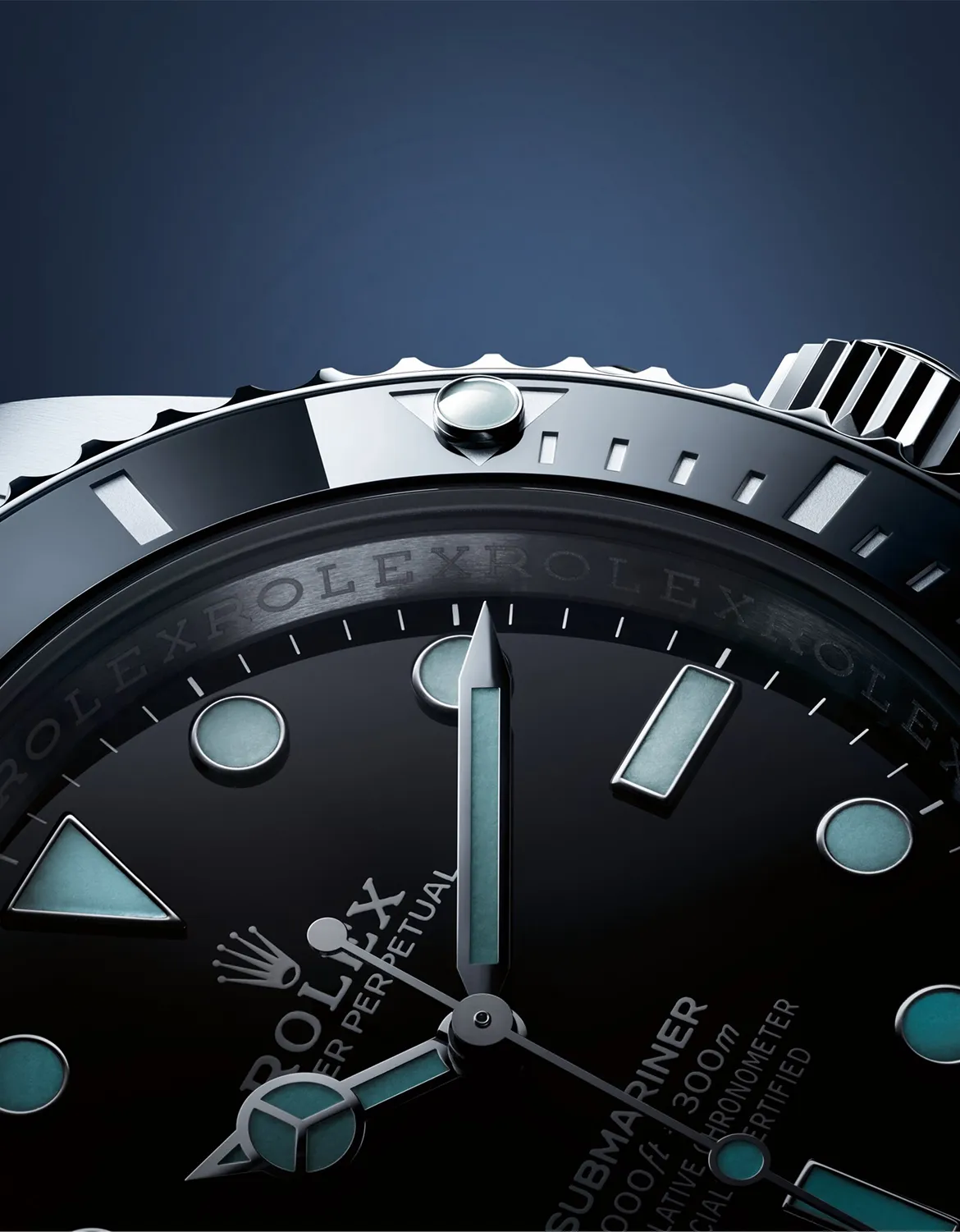 Close-up of a Rolex watch dial and bezel, displaying luminous markers and a ridged crown against a dark blue gradient background.