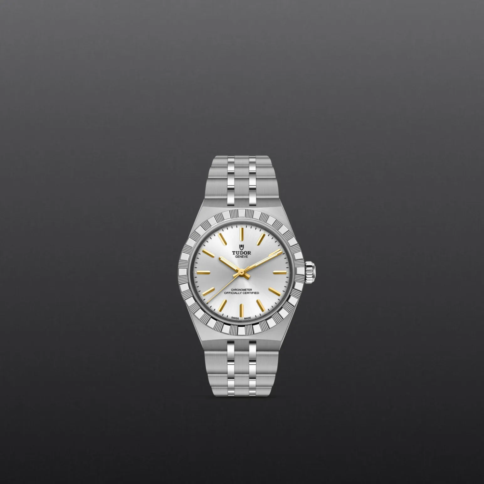 m2830a1a0-0002-upright_watch_grey_background-model_page_only_standard_size | Brela Tudor wristwatch with a stainless steel bracelet, white dial, and gold hands and markers against a dark gray background. | Brela