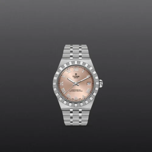 Tudor wristwatch with a steel bracelet and rose-gold dial, date window at 3 o'clock, classic Roman numerals, bezel and hands reflecting light against a dark gray background.
