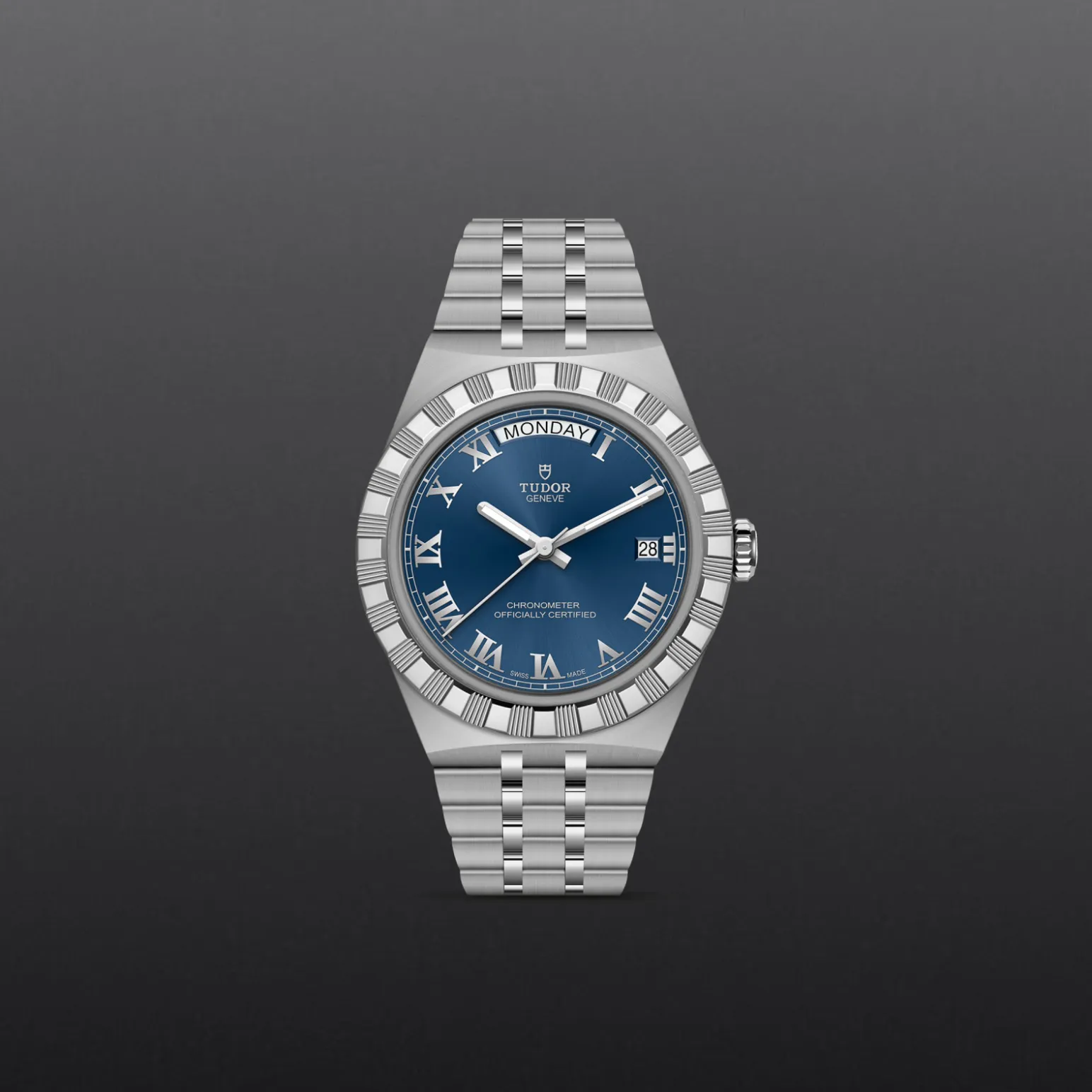 m2840d1a0-0002-upright_watch_grey_background-model_page_only_standard_size | Brela Silver Tudor wristwatch with a blue dial, day window at top, date window at 3 o'clock, and a stainless steel bracelet. | Brela