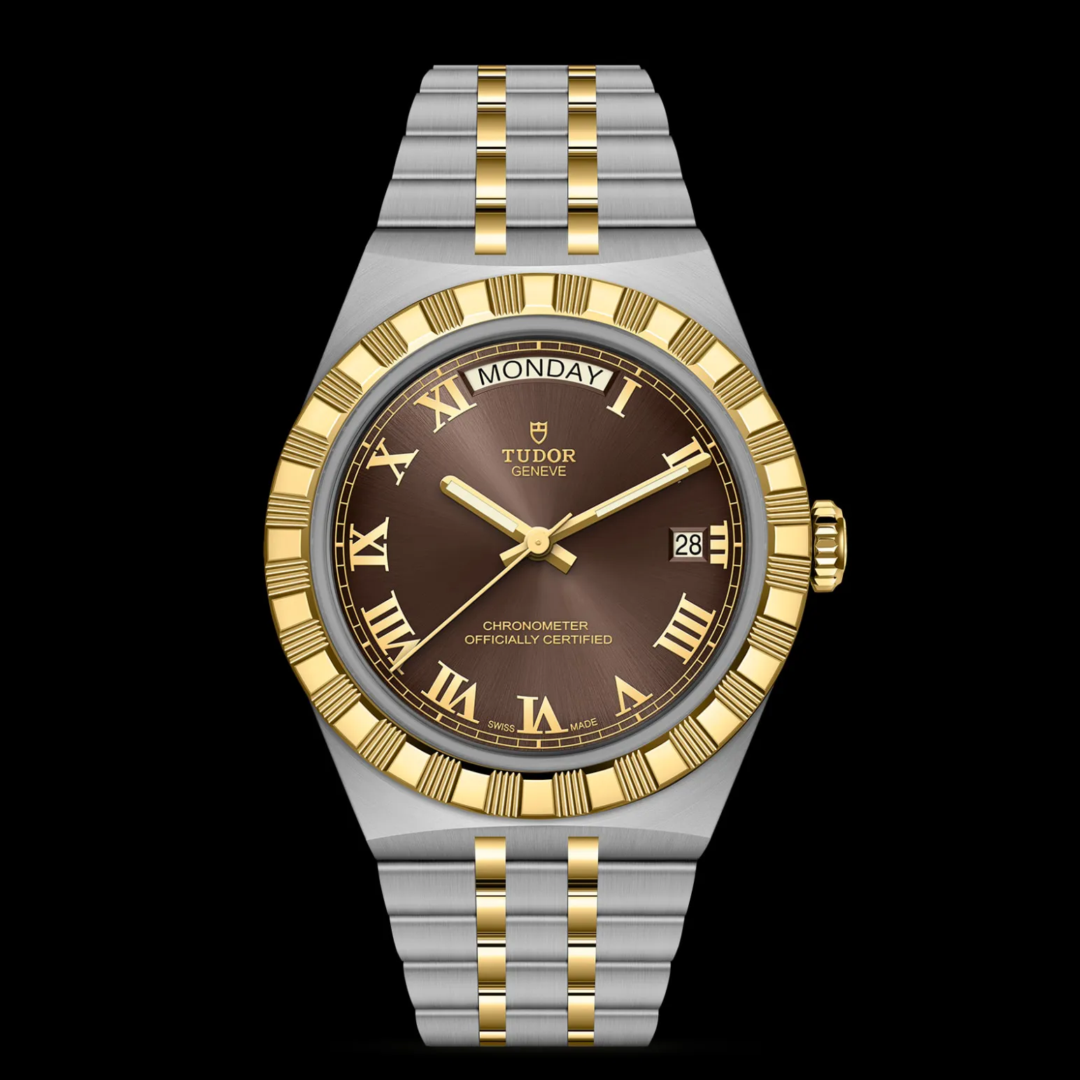 m2840d1a3-0001-upright_watch_black_background_zoomed_in | Brela Two-tone Tudor Genève wristwatch with a gold bezel and silver bracelet, brown dial with Roman numerals, day display at 12, date window at 3, against a black background (informative). | Brela