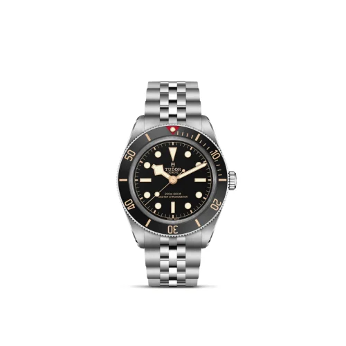 Tudor dive watch with a black dial, beige luminous markers, and a stainless steel bracelet with a rotating bezel.