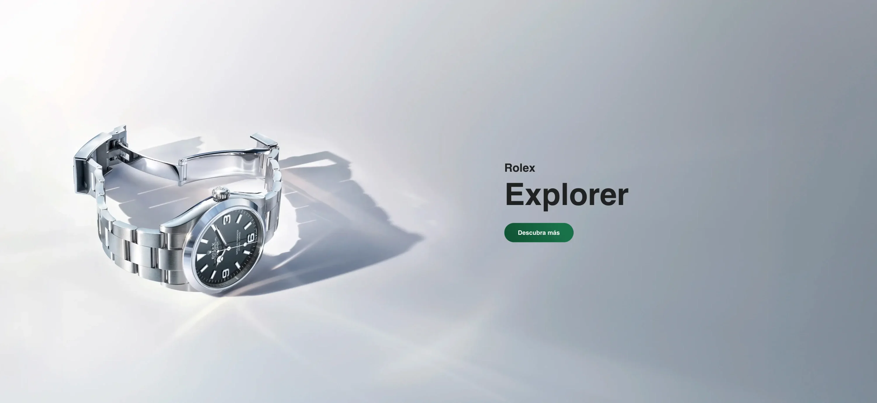 Rolex Explorer advertisement showing a silver wristwatch on the left and a green 'Descubra más' button on the right. | Brela